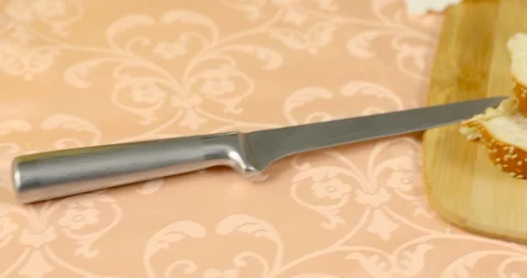 The camera smoothly moves from knife to the sliced challah for Shabbat Stock Footage 117219812
