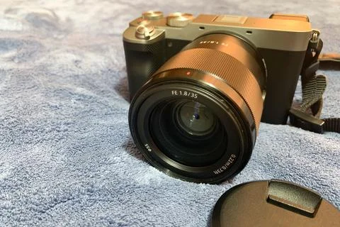 Camera on soft cloth background. Stock Photos