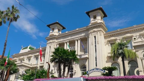 Camera softly moving along the facade of Sanremo Casino with flags of Italy. Stock Footage 94024539