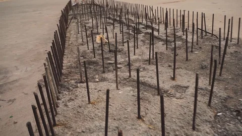 Camera span over metal pins, reinforcement in concrete girl unfinished bridge Stock Footage 128910199