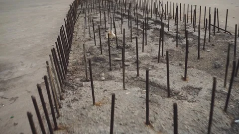 Camera span over metal pins, reinforcement in concrete girl unfinished bridge Stock Footage 128910282