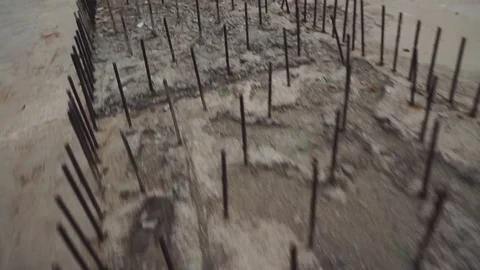 Camera span over metal pins, reinforcement in concrete girl unfinished bridge Stock Footage 128910342