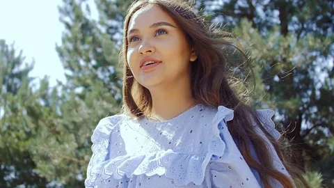 The camera is spinning around a young beautiful woman with long hair. Stock Footage 78710681