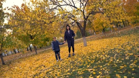 Camera spinning on two people strolling in park Stock Footage 98668193