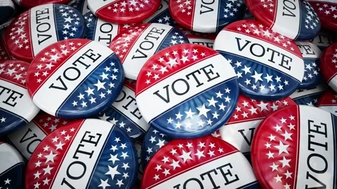 Camera spins and zooms into large stack of vote badges with American flag Stock Footage 285501758