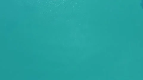 The camera spins as it falls towards the sea. Sea surface, aerial drone video Stock Footage 301906137