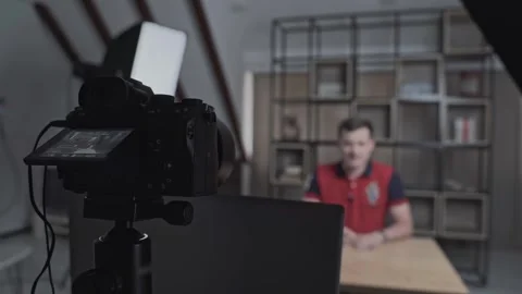 Camera stands on tripod and shoots interview of man. Stock Footage 283307460