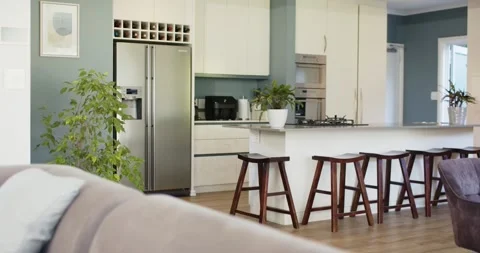 Camera starting to pan is sweeping open kitchen and island, revealing appliances Stock Footage 342595997