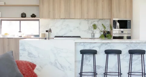 Camera is starting slow left pan in open-plan kitchen, revealing marble island Stock Footage 337238705
