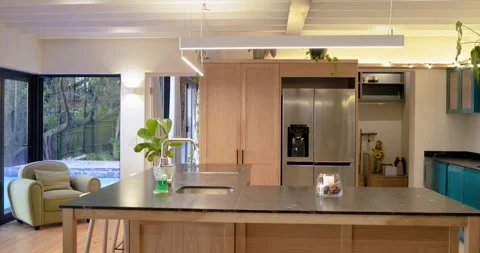 Camera is starting slow pan across kitchen interior, highlighting stone island Stock Footage 336367185