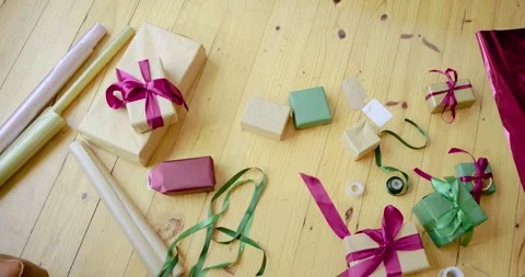 Camera is starting slow pan across gift-wrapping supplies on tabletop, revealing Stock Footage 336535177