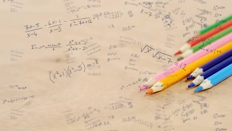 Camera starting slow pan refocusing across paper and moving colored pencils Stock Footage 334729157