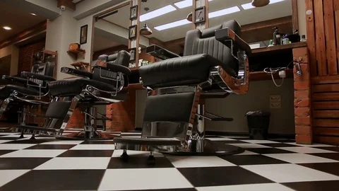 The camera on the Steadicam shows the interior of a Barber shop with a beautiful Stock Footage 82191667