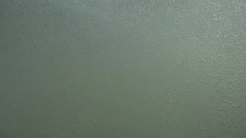 The camera submerges, goes under the water. The concept of reigning while mel Stock Footage 165057418