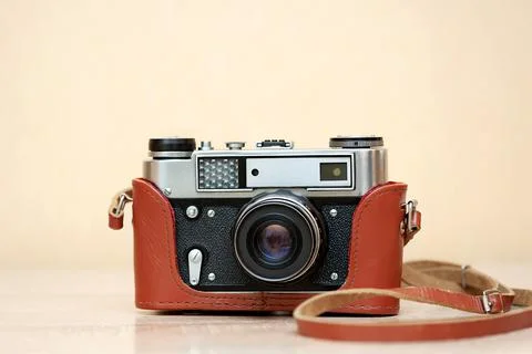 Camera on table and neutral background close up Stock Photos