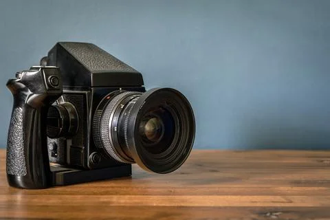 Camera is on the table. Medium format analog film camera on a blank background Stock Photos