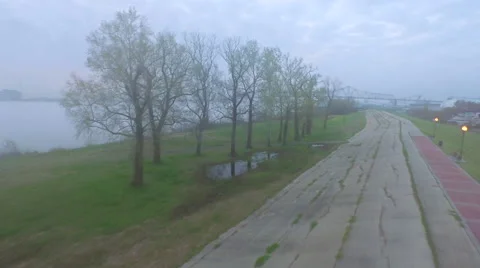 Camera takes off from road, turns to see skyline, sunrise, Baton Rouge, LA, Stock Footage 53369006