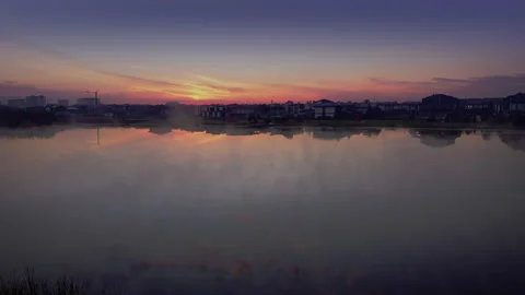 The camera takes off from the shore of a lake covered in fog. Stock Footage 204880802