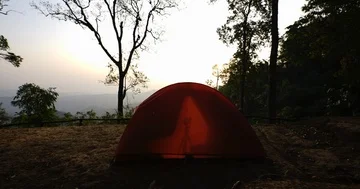 Camera taking a sunrise shot at camping site : time lapse shot Stock Footage 85847910