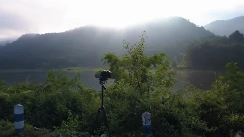 Camera taking timelaps video beside a lake at chiang mai Stock Footage 100824449