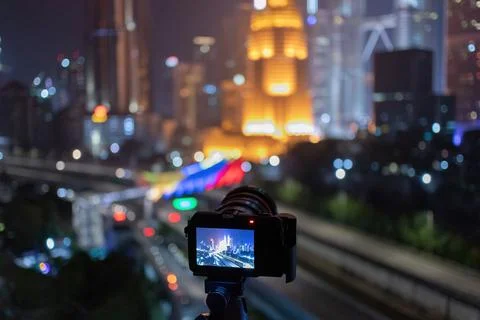 A camera taking a view of kuala lumpur city skyline at night Stock Photos
