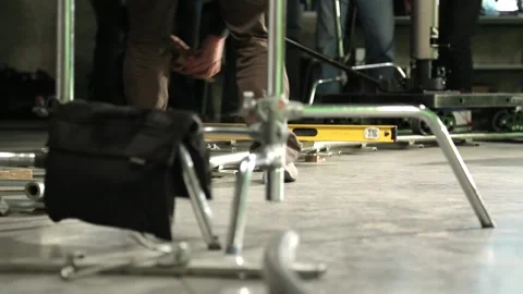 Camera technician setting up the track for dolly Stock Footage 238001822