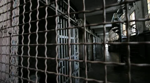 Camera through grill bars to prison detention area cells Stock Footage 10923761