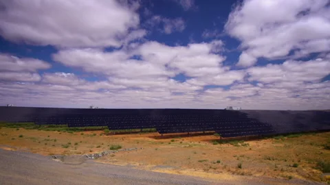 Camera Tilt Down To Large Solar Farm Showing Solar Panels Into The Distance Stock Footage 150991126