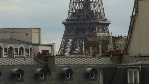 Camera tilt from the iconic Parisian rooftops to the top of the World Famous Stock Footage 72119642