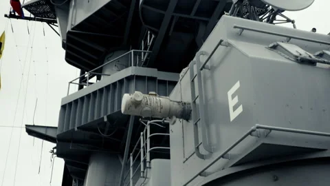 Camera Tilt Up from Navy Ship Deck to Radar Dishes and Anti-Aircraft Gun Stock Footage 322052608