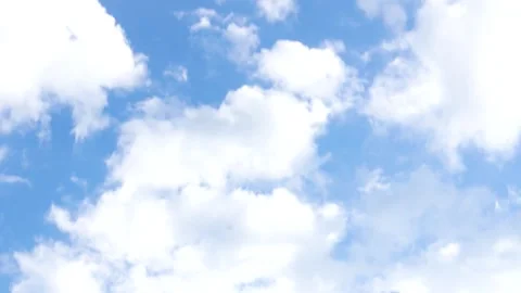 Camera tilt reveals layered white clouds in deep blue sky Stock Footage 312758216