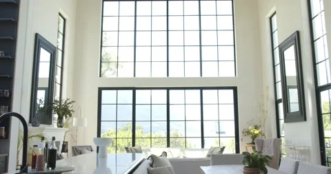 Camera is tilting and dollying revealing living or dining area with grid windows Stock Footage 336437700