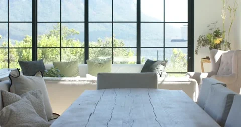 Camera is tilting up and pulling back to reveal rustic dining table, sofa, Stock Footage 340069970