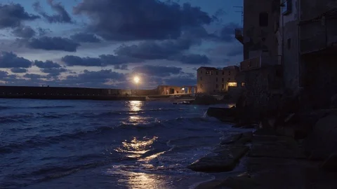Camera tilting down from apartments to the ocean in Cefalu Stock Footage 88518632