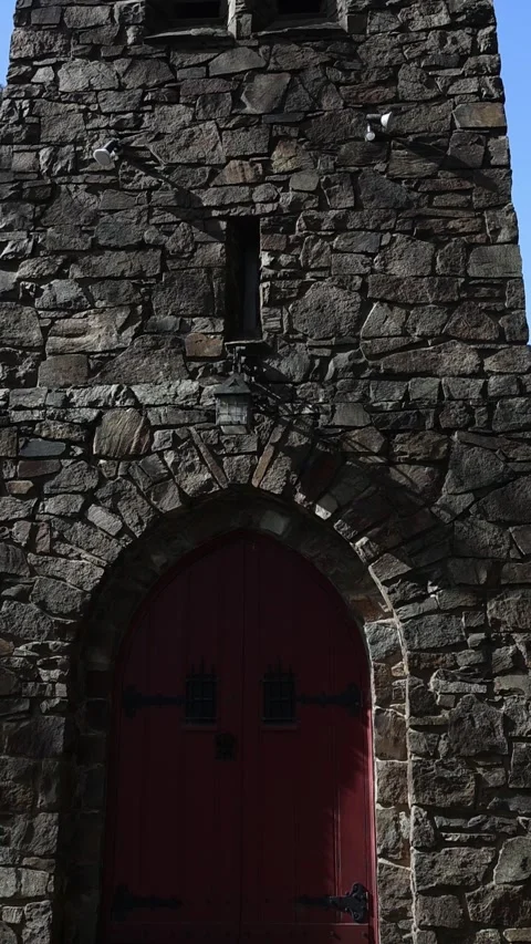 Camera tilting down a medieval stone church tower Stock Footage 341912500