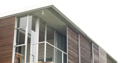 Camera is tilting down, revealing upper balcony with stool and wood slat Stock Footage 342363183