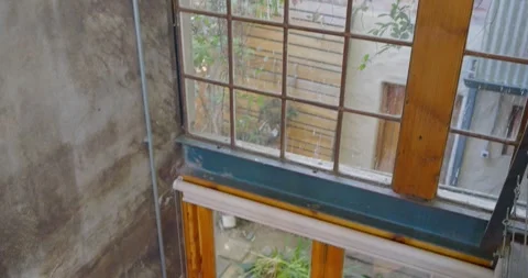 Camera is tilting downward to reveal cast-iron spiral staircase and terracotta Stock Footage 342023481