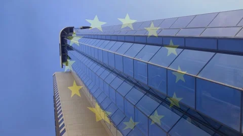 Camera tilting up, glass tower anchoring frame while yellow star ring drifting, Stock Footage 333494489