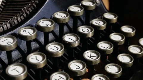 Camera tilting on a old black vintage manual typewriter keyboard Stock Footage 75210477