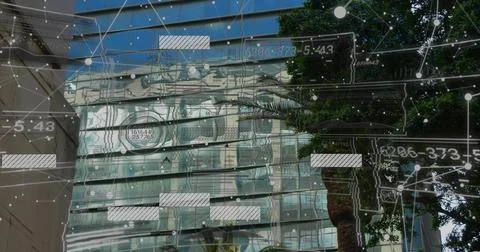 Camera tilting upward starting data overlay glass office tower hosting sliding Stock Photos