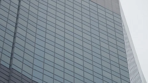 Camera tilts up against a generic high rise building, great for exterior office Stock Footage