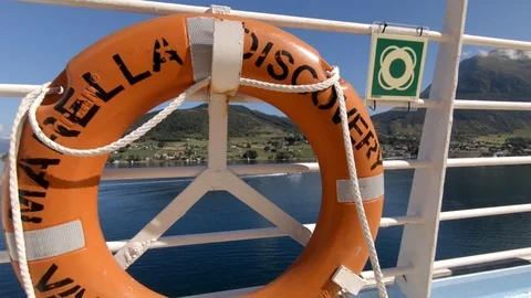 Camera tilts up from the deck of cruise ship to reveal a fjord 動画素材 93460597