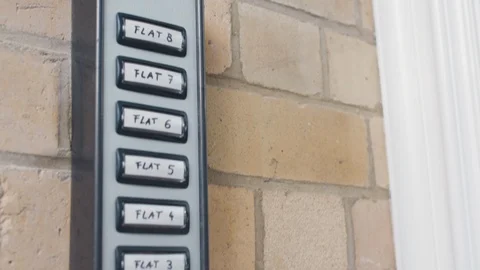 Camera tilts down lookign at intercom unit on building. Video stock 102638941