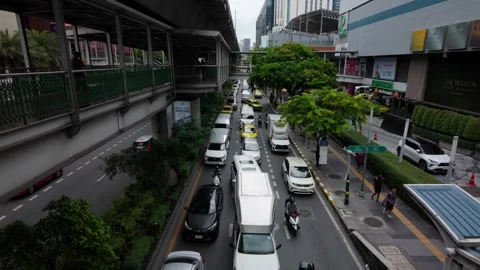 Camera tilts down to traffic on the Sukhumvit Road Stock Footage 295107382