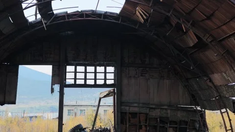 Camera tilts up to reveal collapsed wooden roof and exposed beams Stock Footage 345931508
