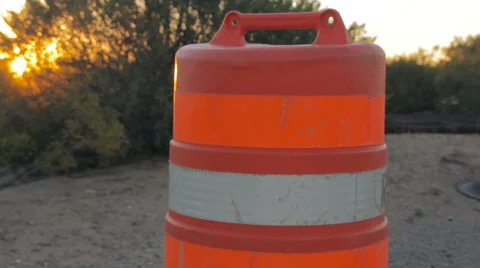 Camera Tilts to Reveal an Orange Traffic Drum Stock Footage 64364355