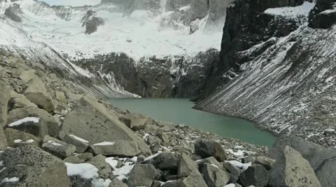 Camera tilts up to reveal towering peaks in Torres del Paine national park Stock Footage 12498703