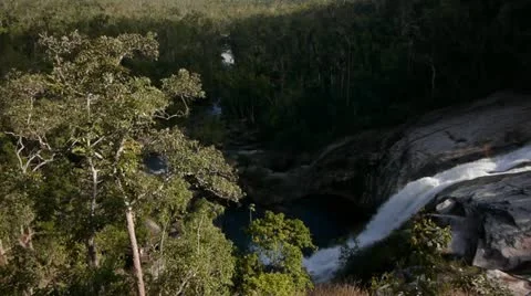 Camera tilts up from waterfall to distant mountains Stock Footage 11235780