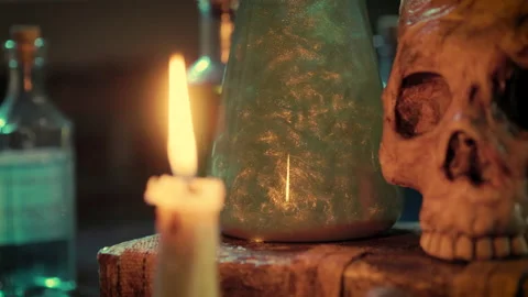 Camera tilts from window to magic potion and skull Stock Footage 213706544