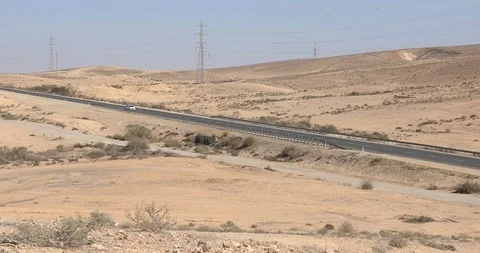Camera track a car who is moving on road in desert Negev at winter Stock Footage 102250658